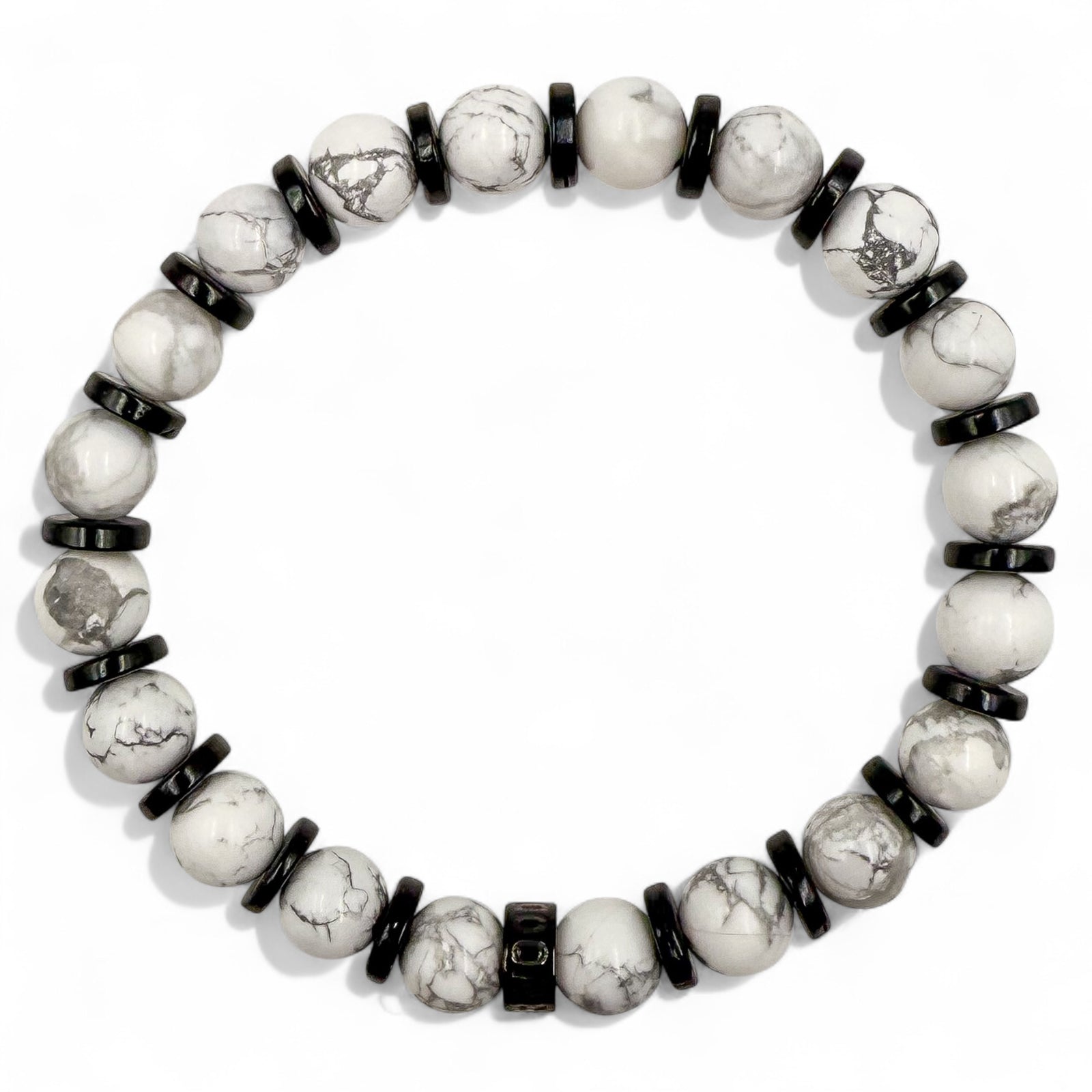 Overhead view of Pulse men’s beaded bracelet made with white howlite and blackwood beads