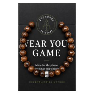 Wooden bracelet on a black card with branding and text